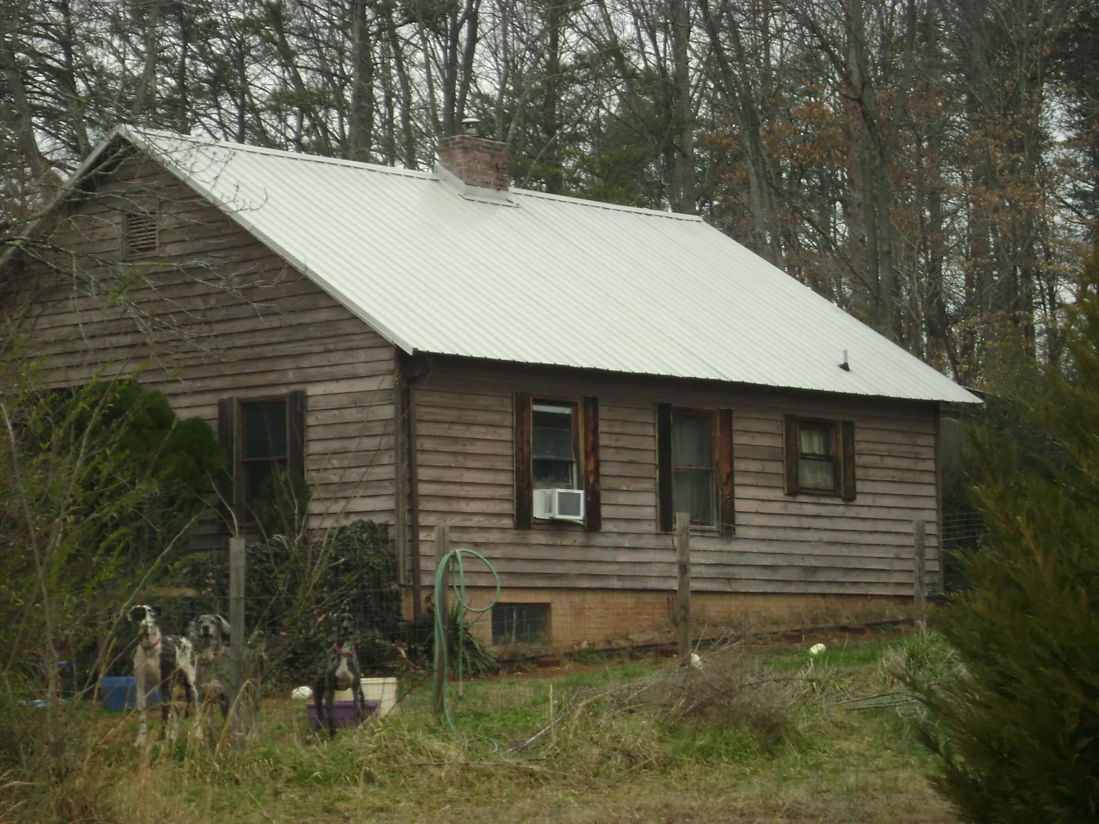 White metal roof on an old wood sided farmhouse, from a Metal Roof Installation job in Morristown